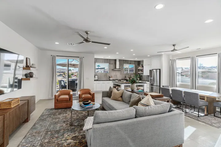 Open-concept living space featuring a sliding glass door to the exterior, recessed lighting, and multiple ceiling fans