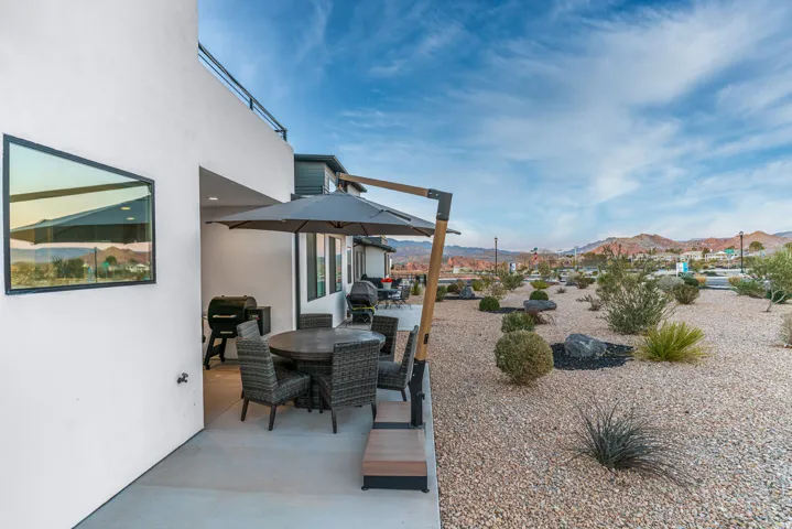 Outdoor patio featuring a concrete surface, built-in recessed lighting, and a modern exterior wall