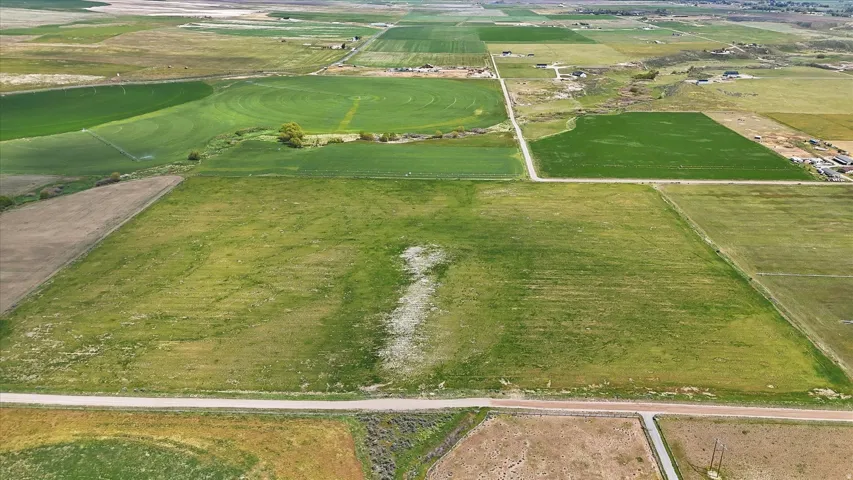 Expansive land parcel featuring existing road frontage and a verdant, level topography