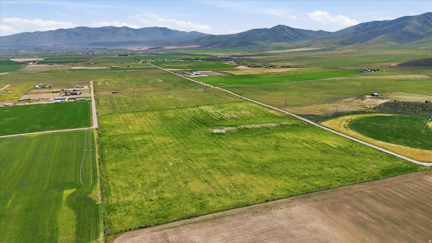 Expansive agricultural land featuring a mix of cultivated fields and open pasture