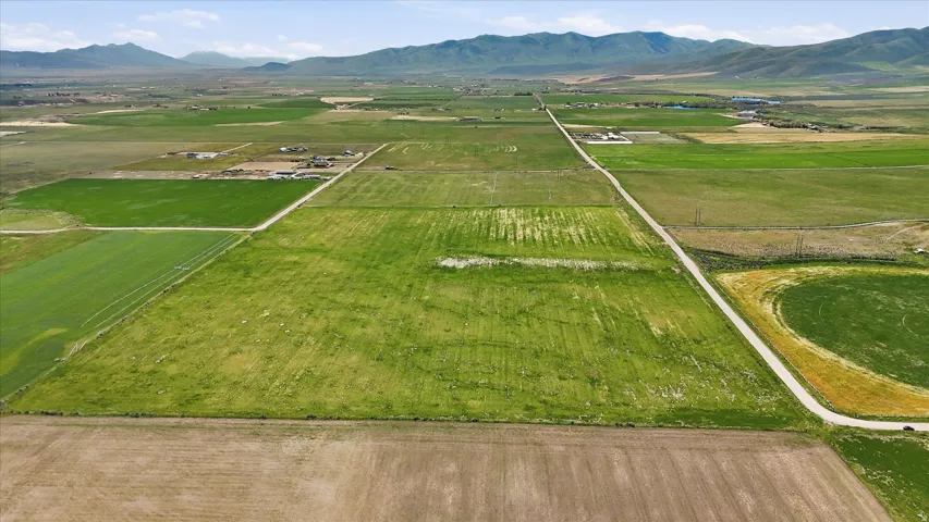 Expansive agricultural land featuring a mix of cultivated fields and open pastures