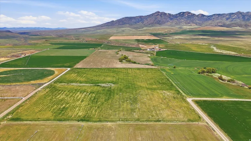 Expansive agricultural land featuring a variety of cultivated fields, including circular and rectangular plots