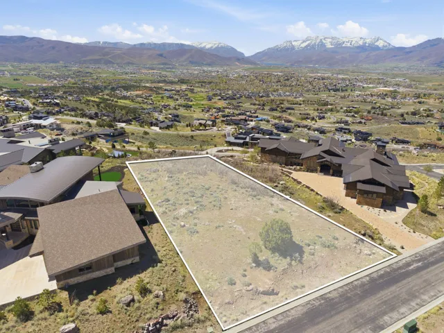 Aerial perspective of suburban area with property boundaries highlighted and mountains