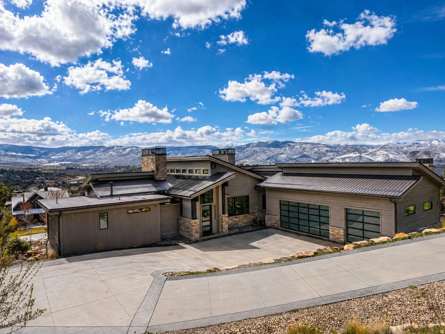 Contemporary exterior featuring earth-toned siding and stone accents