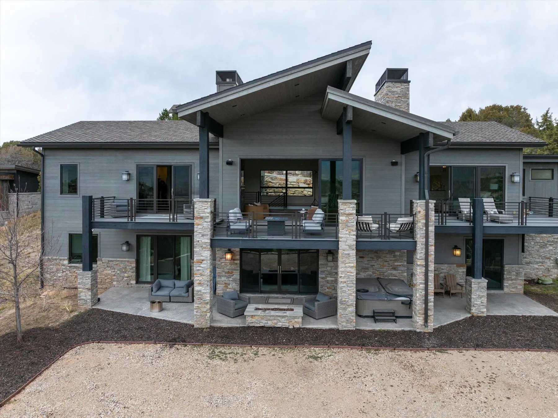 Multi-level contemporary exterior featuring extensive decking and stone accents