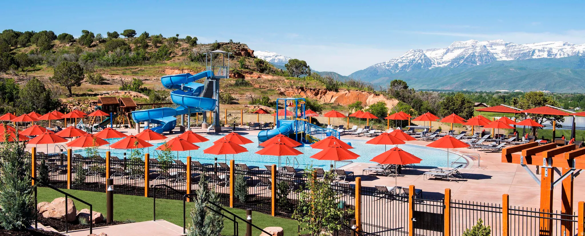 Resort-style aquatic amenity featuring multiple pools and water slides