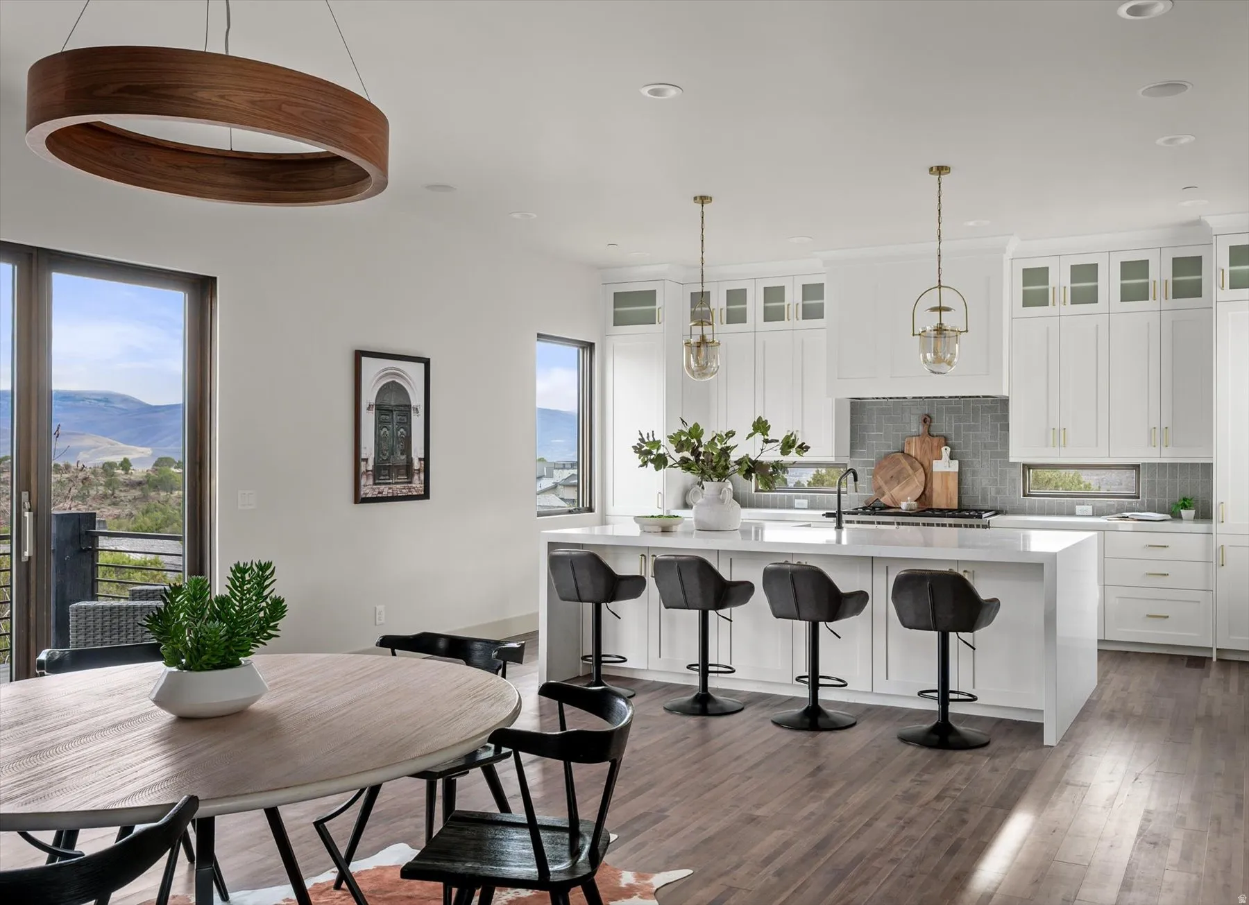 Updated kitchen and dining area featuring wood-finish flooring