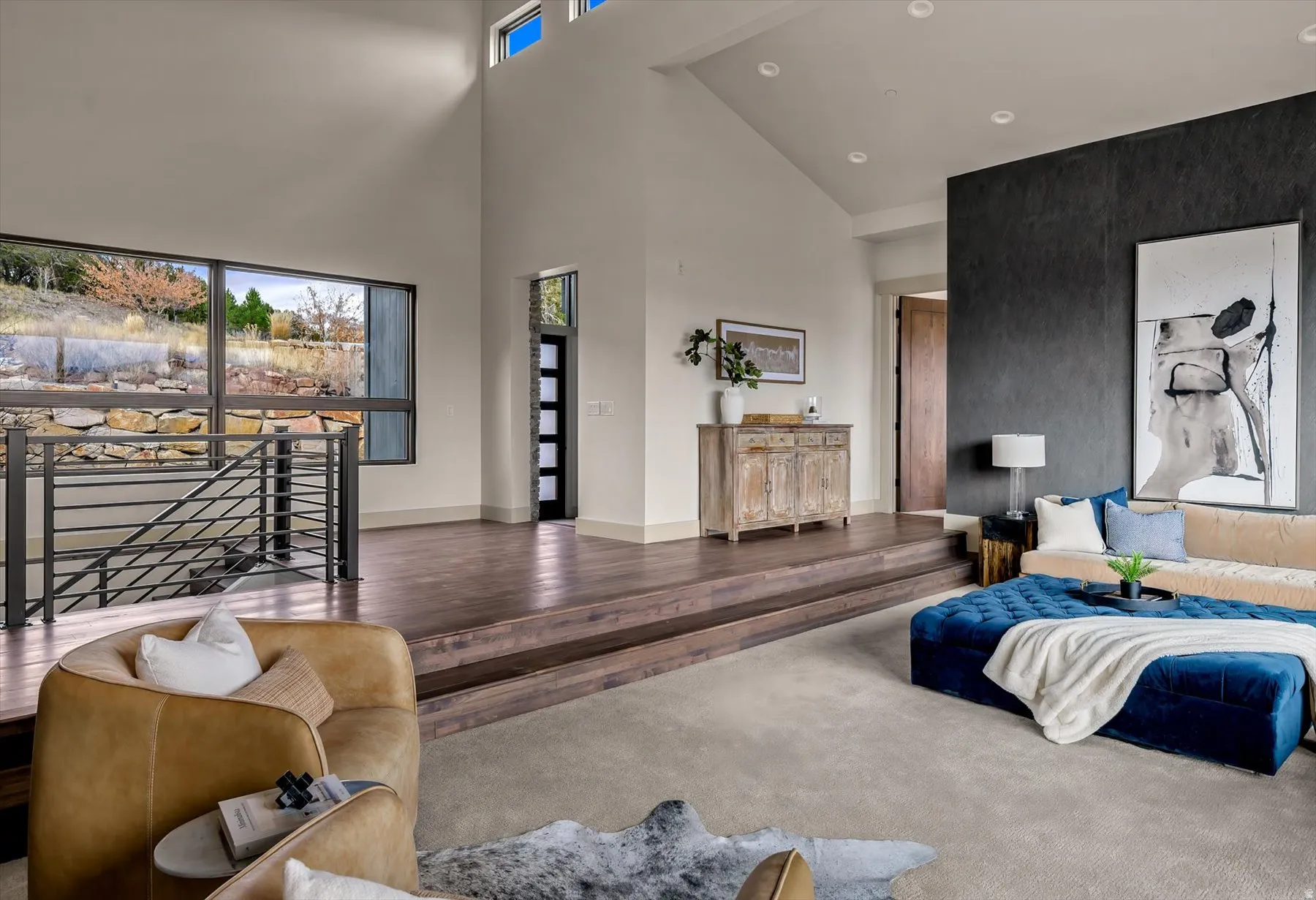 Vaulted ceilings accent a multi-level living space with large picture windows.