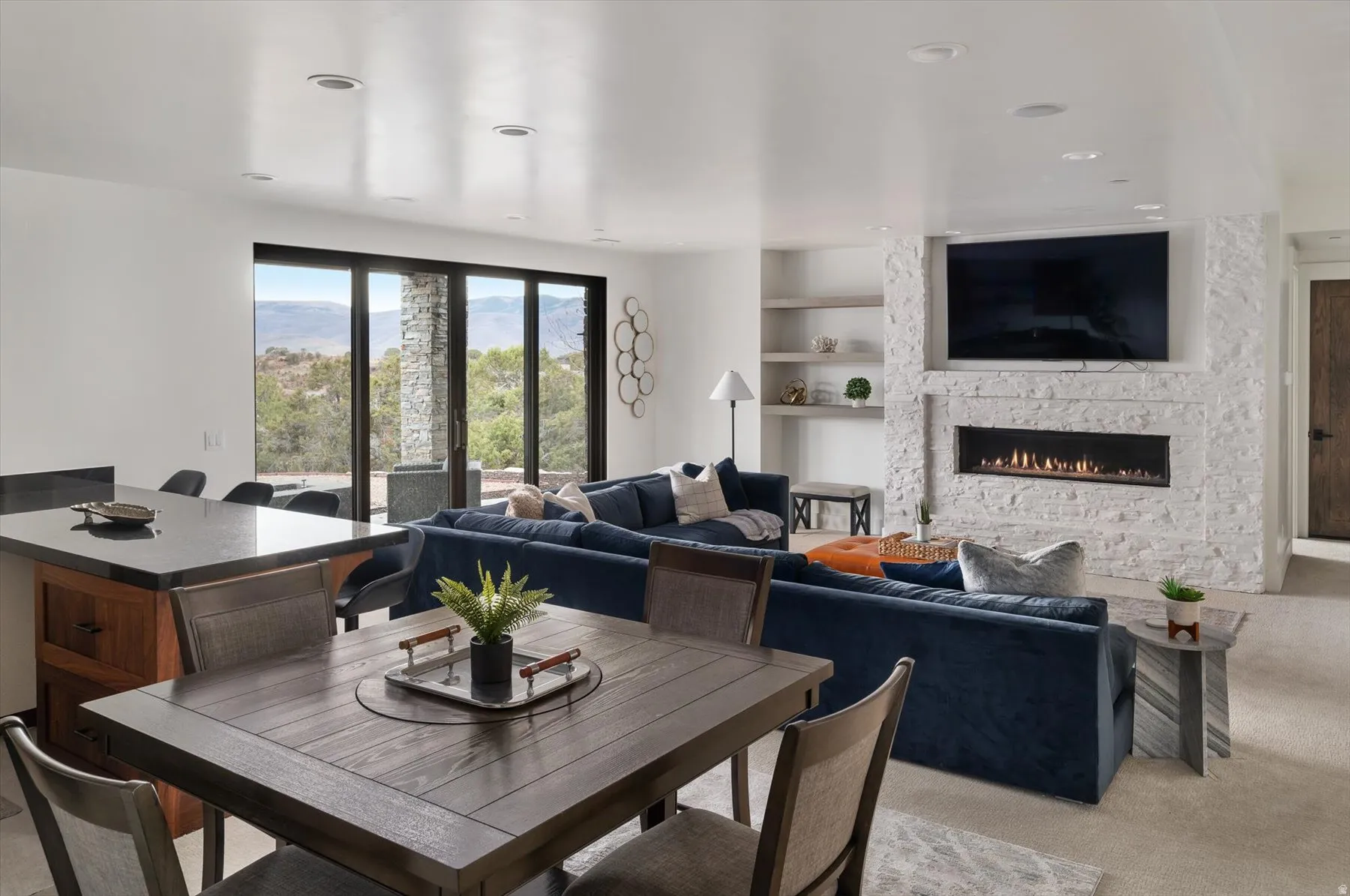 Open-concept secondary living space featuring large sliding glass doors to back porch.
