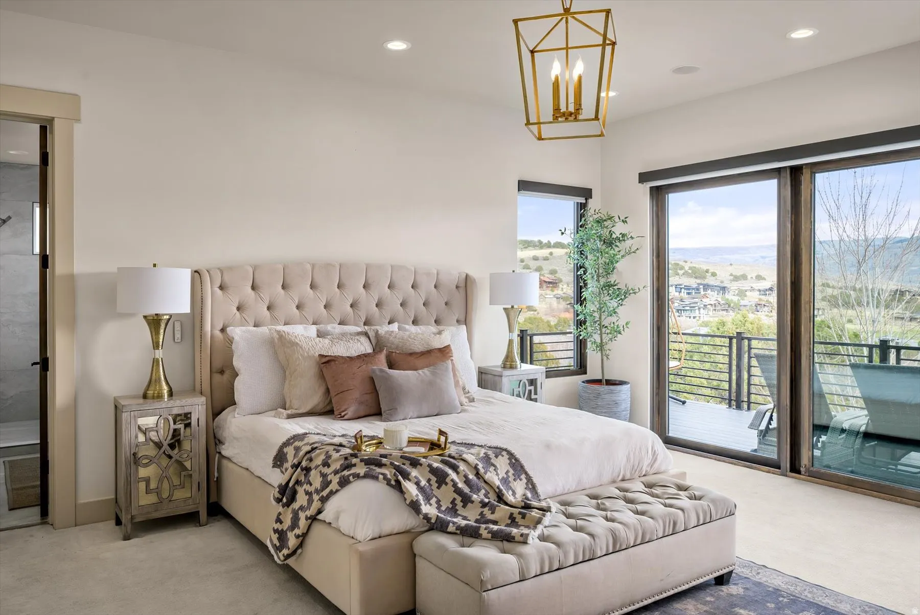Spacious master bedroom featuring large sliding glass doors, and automatic shades.