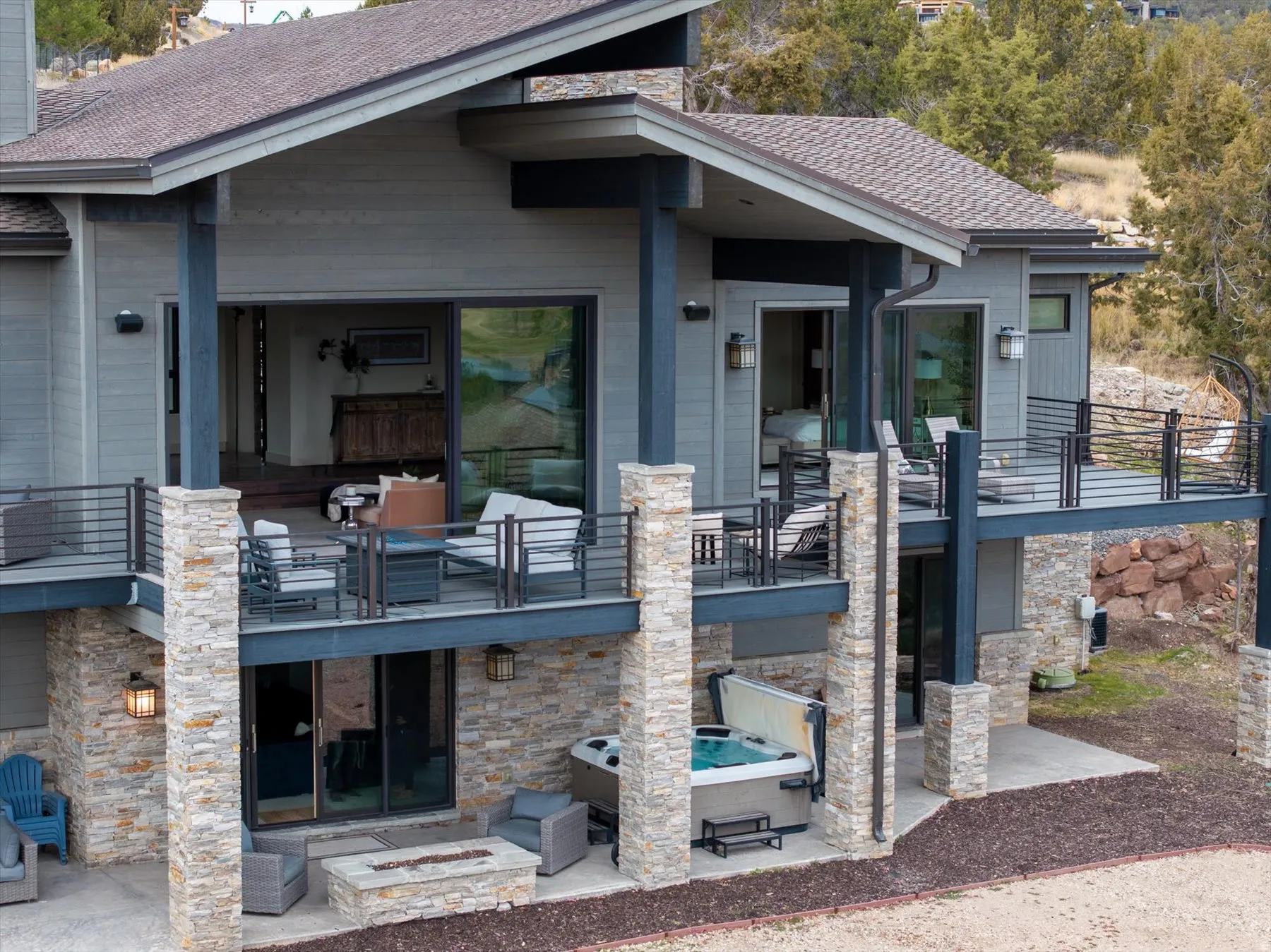 Contemporary multi-level exterior with stone veneer accents and horizontal siding