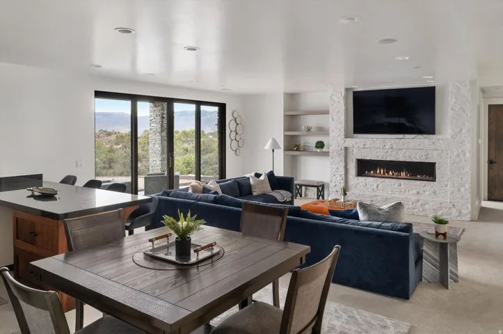 Open-concept secondary living space featuring large sliding glass doors to back porch.