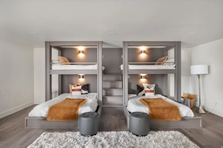 Built-in bunk beds with integrated lighting, wood-finish flooring, recessed ceiling lights,