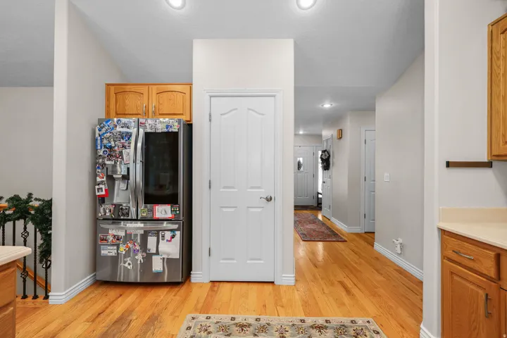 Hardwood flooring extending through the hallway