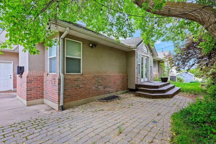 Paved patio area with a brick and stucco exterior