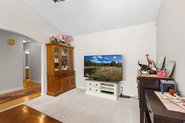 Vaulted ceiling over carpeted flooring