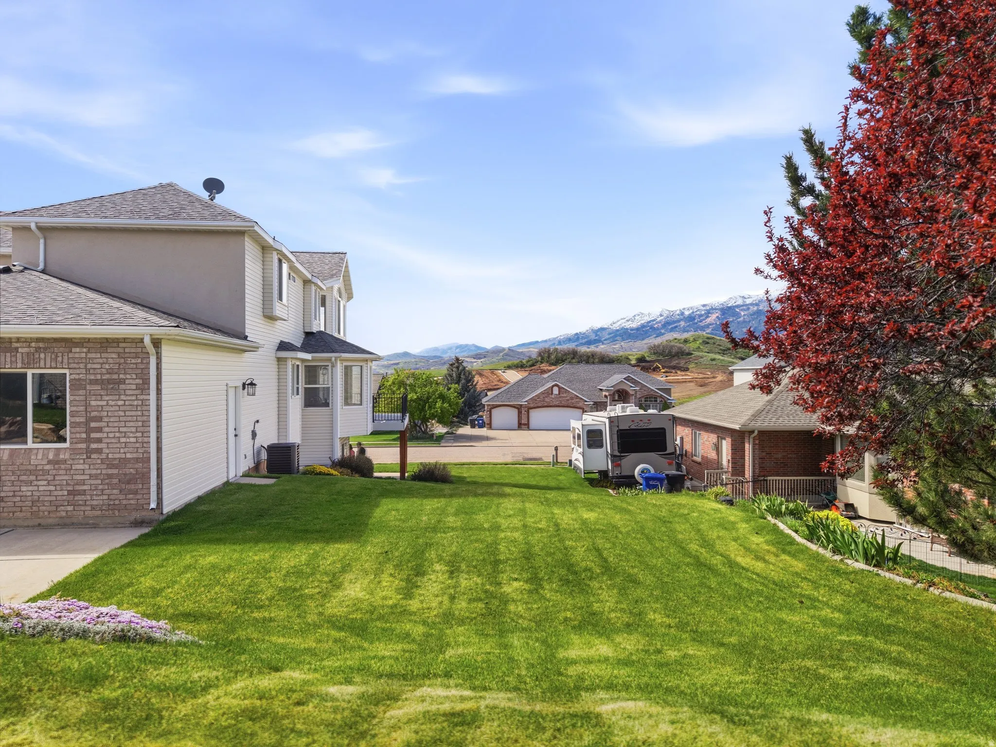 Expansive green lawn with mountain backdrop