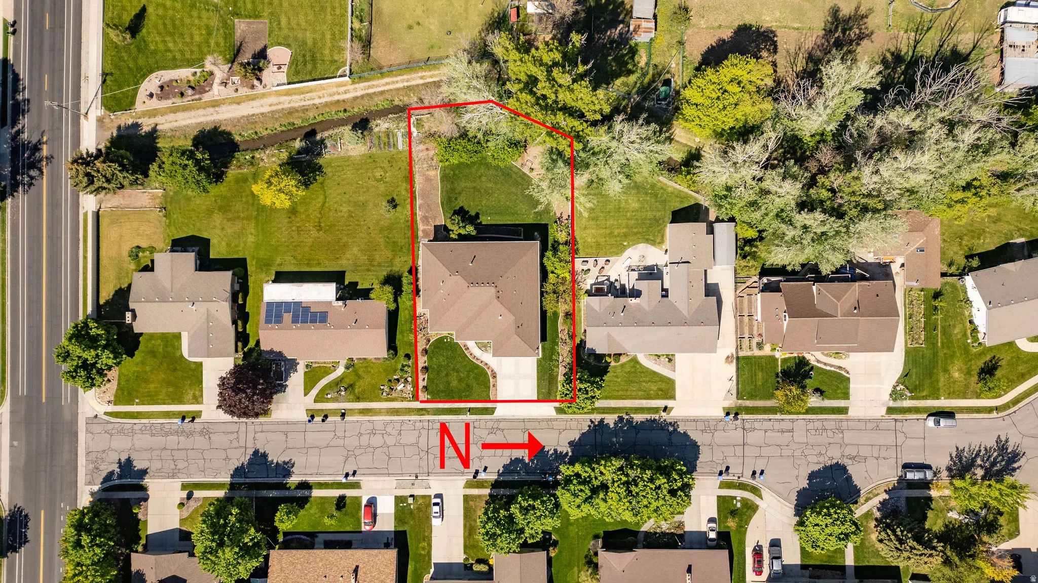 Aerial view showcasing a residential property with a defined lot perimeter