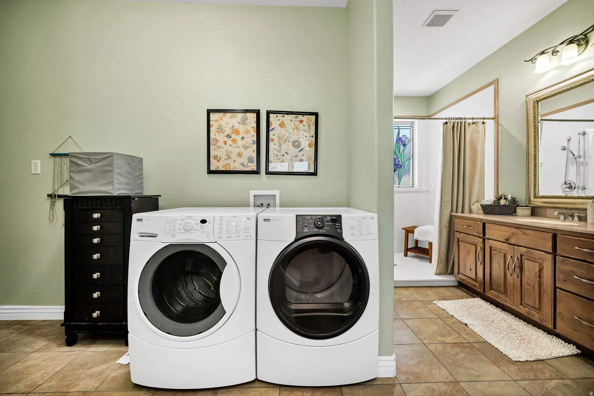 Integrated laundry area featuring a front-loading washer and dryer