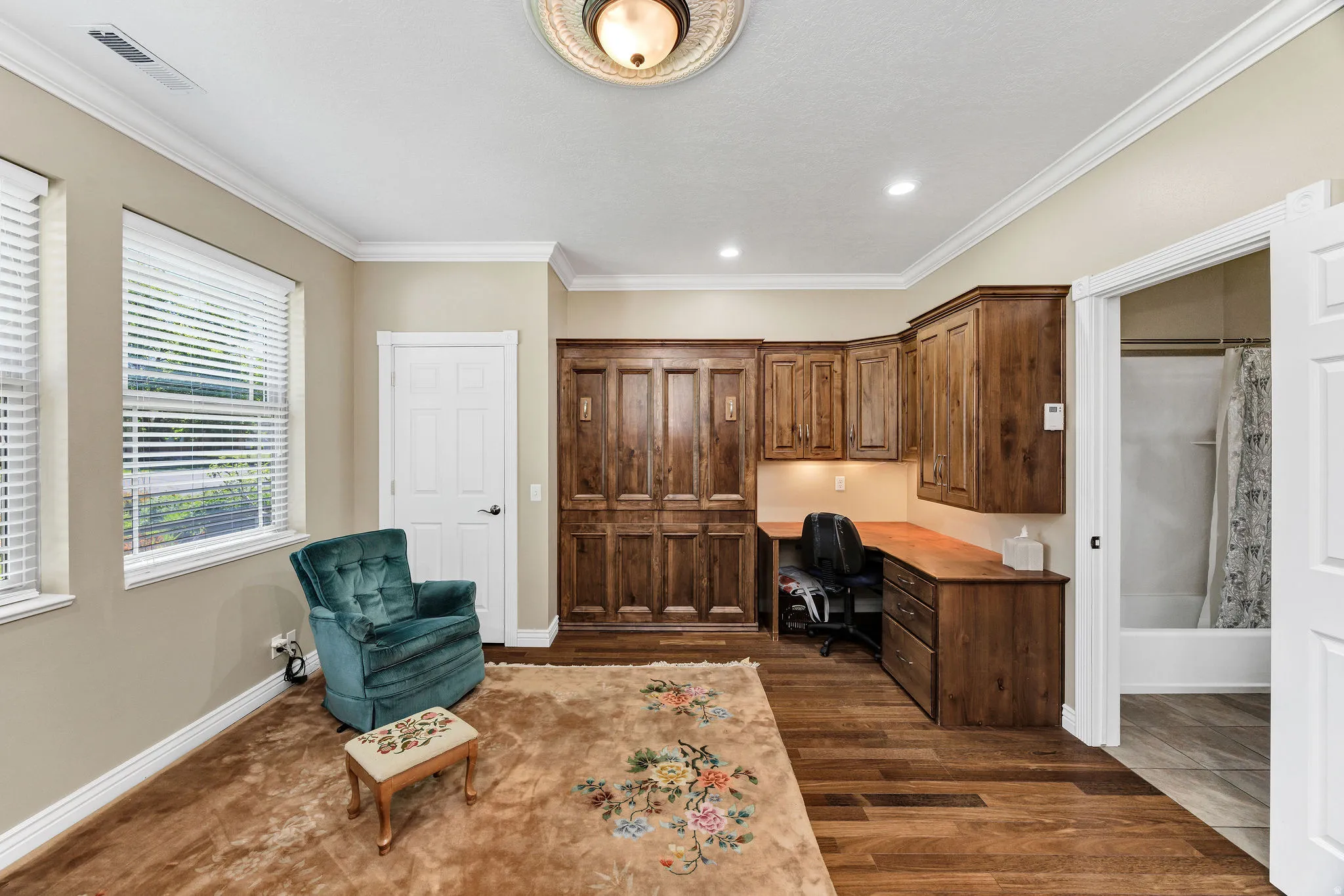 Room featuring built-in wood cabinetry, integrated desk space, and recessed lighting