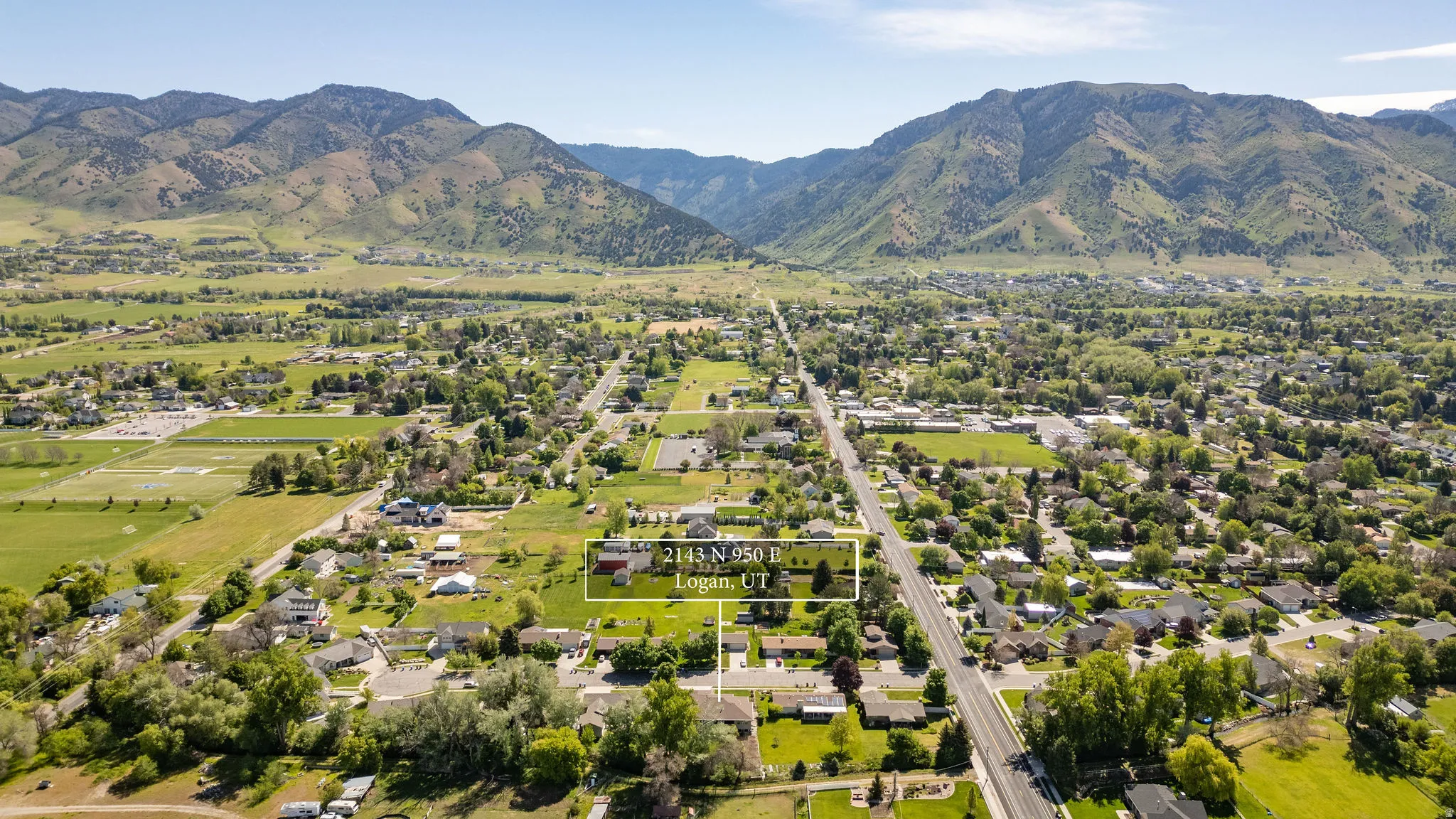 Expansive aerial perspective showcasing the property within a verdant valley setting