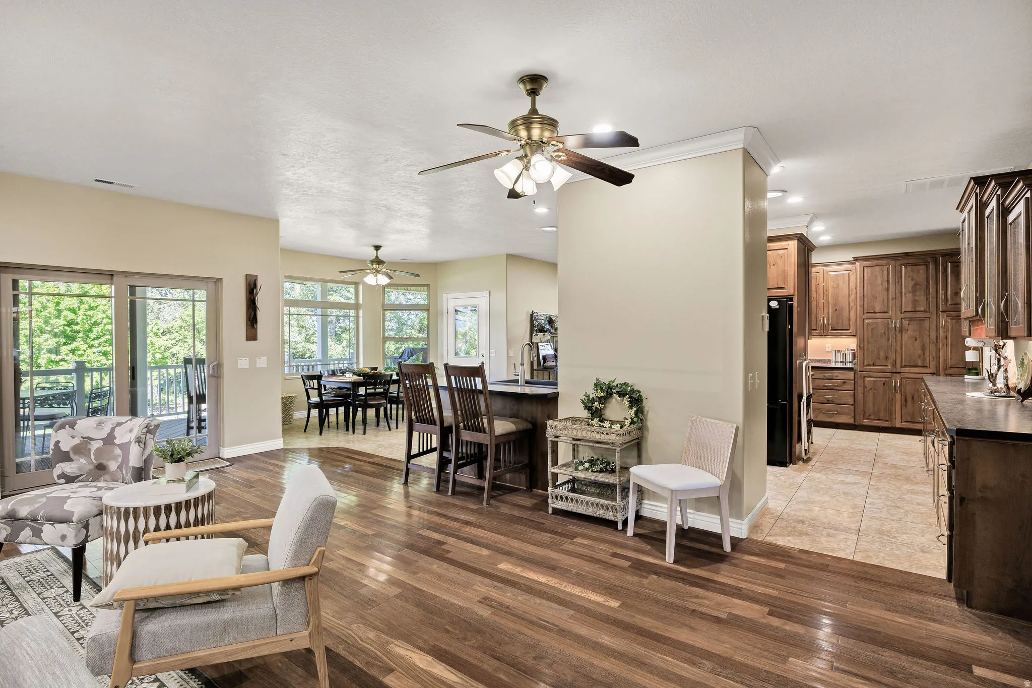 Open-concept living area featuring rich wood-finish flooring, recessed lighting, and a ceiling fan