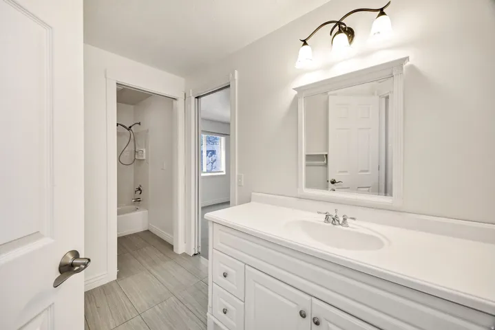 White vanity with integrated sink and chrome fixtures