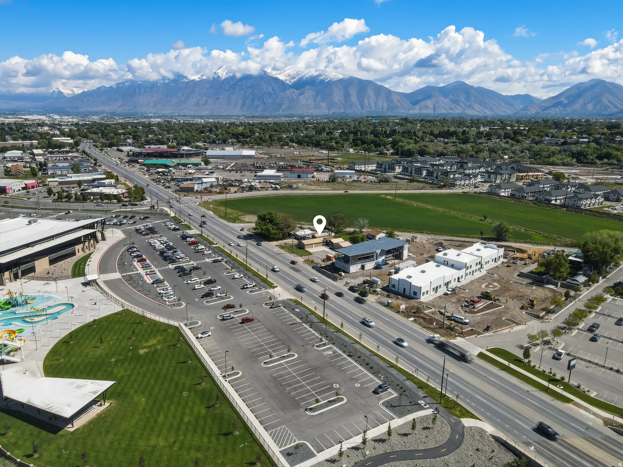 Expansive aerial view showcasing a commercial property with mountain scenery