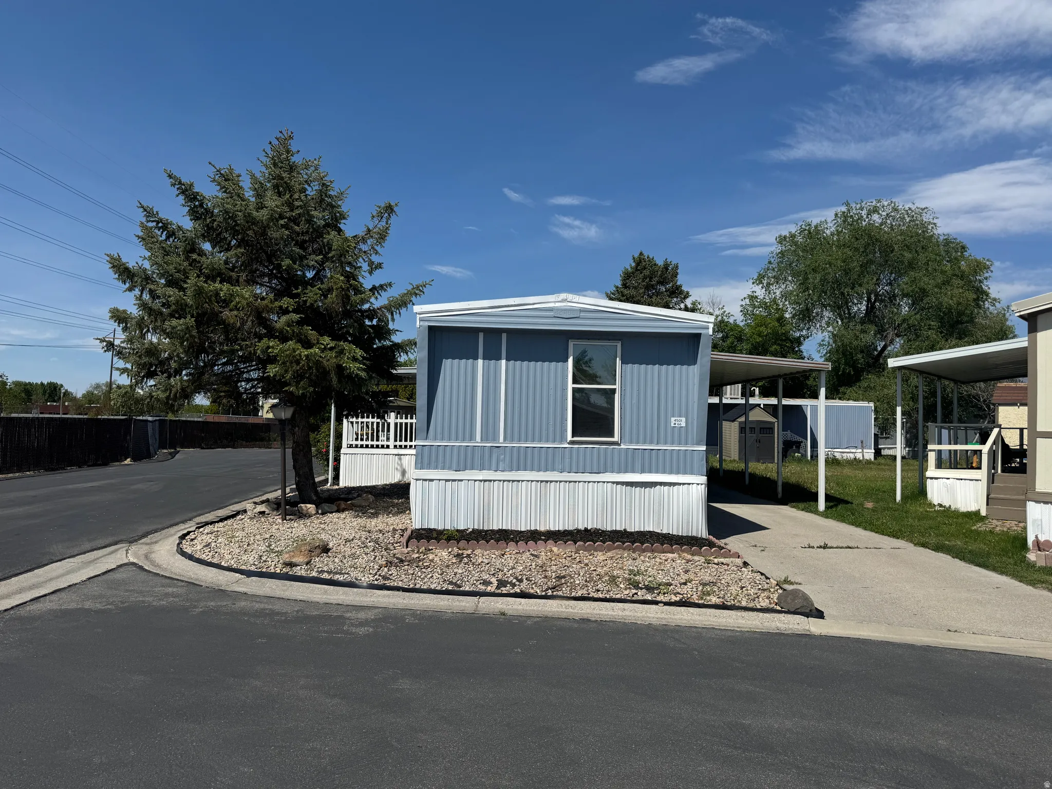 Light blue siding exterior with white trim and skirting