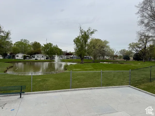 Concrete patio overlooking a pond with a fountain feature