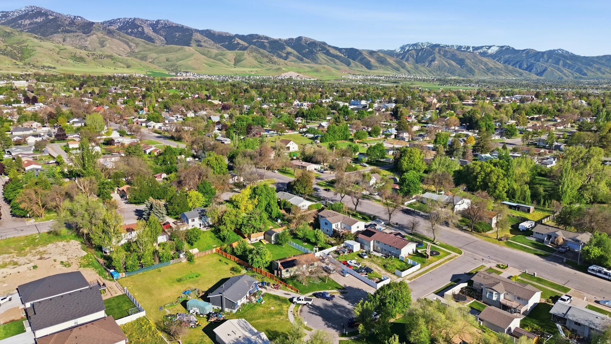 Aerial perspective showcasing a residential area with varied home styles and mature trees