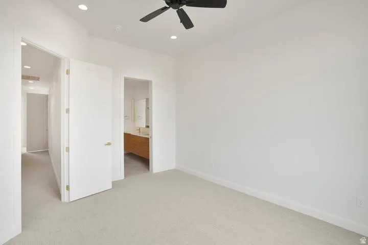 Carpeted room with recessed lighting and a ceiling fan
