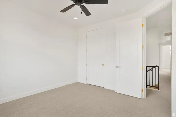 Neutral-toned carpeting paired with crisp white walls