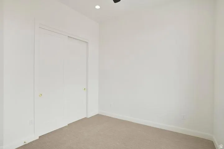Neutral color palette featuring light beige carpeting and white walls