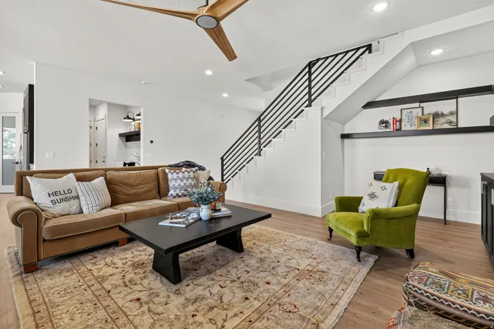 Open-concept living space featuring wood-finish flooring, recessed lighting, and a contemporary ceiling fan