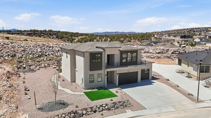 Contemporary two-story residence with a dual-tone stucco exterior and a dark asphalt shingle roof