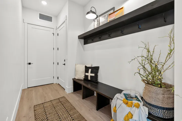 Entry area featuring wood-finish flooring and a built-in dark wood bench