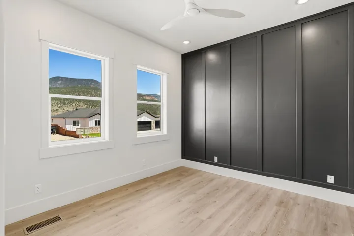 Feature wall with dark paneling and a light wood-finish flooring