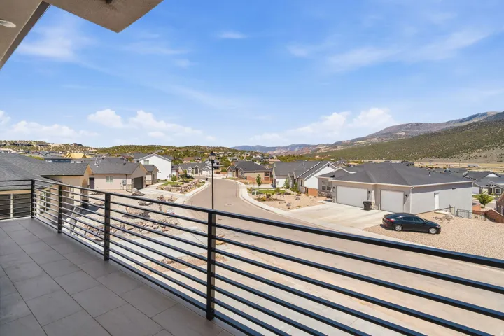 Elevated patio with tiled flooring and sleek horizontal metal railing