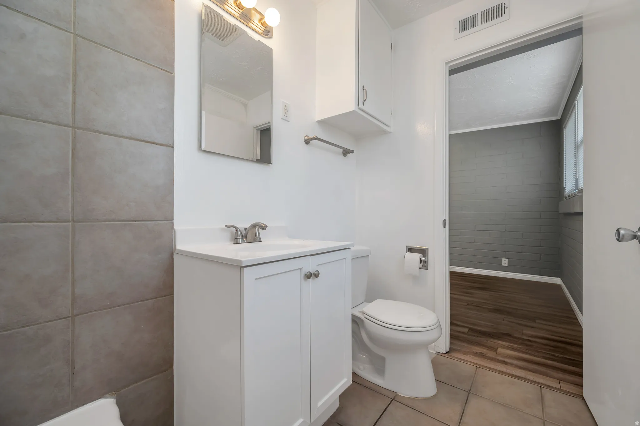Bathroom with vanity and light tile patterned floors