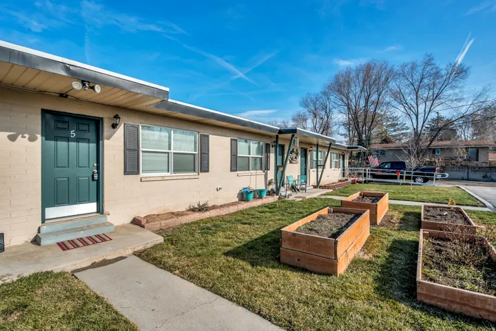 Doorway to property featuring a yard and concrete block siding