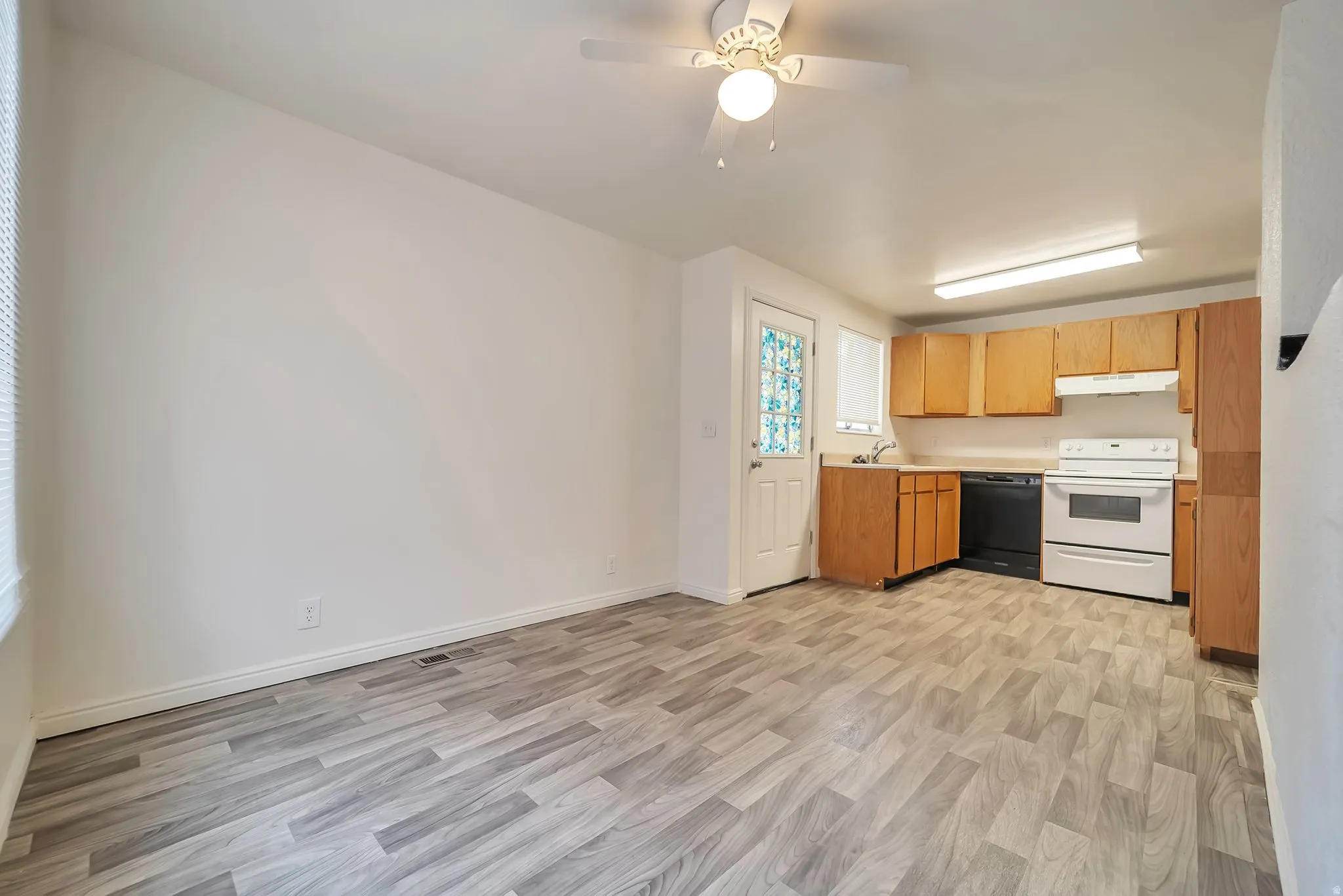 Open-concept living space featuring wood-finish flooring