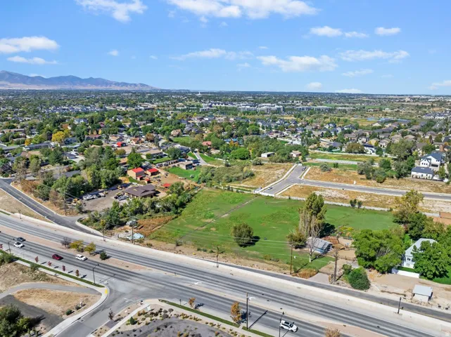 Expansive aerial perspective showcasing a residential landscape with varied housing styles and mature tree coverage