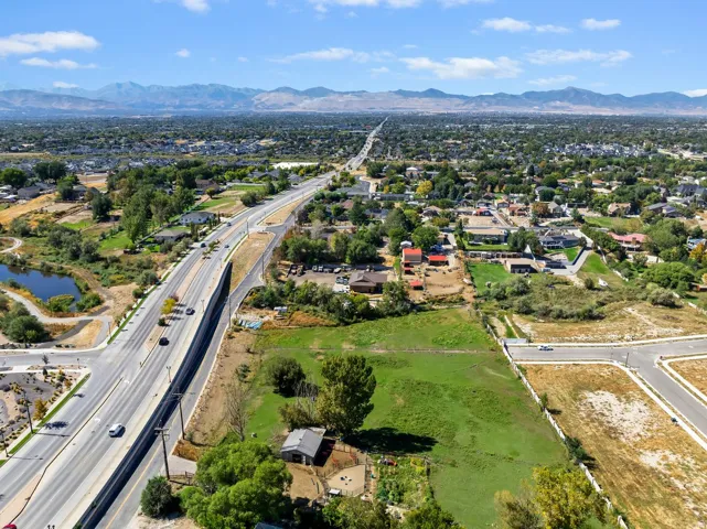 Expansive aerial capturing a wide urban and suburban landscape with distant mountains