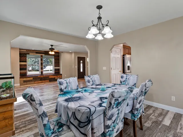 Dining space featuring a decorative chandelier and wood-finish flooring