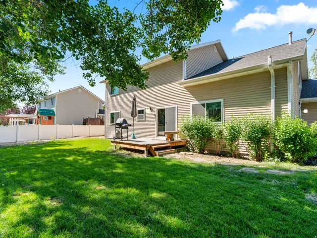 Expansive green lawn with a privacy fence