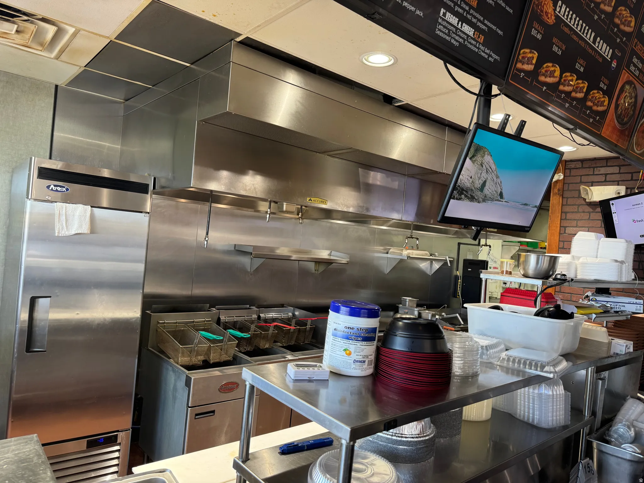 Commercial kitchen space featuring stainless steel appliances and fixtures