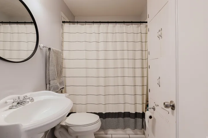 White ceramic pedestal sink with chrome faucet hardware