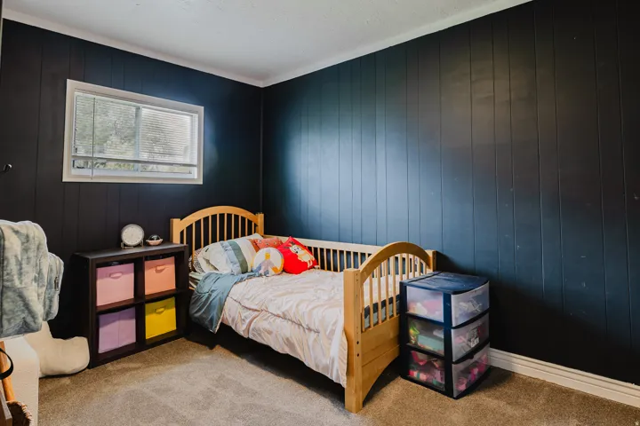 Dark-paneled wall with white trim and a single-pane window