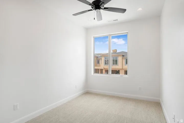 Room featuring a single window, recessed lighting, and a ceiling fan